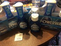Two unopened triple packs of Dawn Ultra Platinum Powerwash and two loose bottles on table.