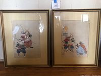 Pair of framed antique Japanese samurai paintings, both signed and tagged, showing full view of each artwork.