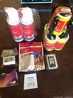 Lot showing 2 red and white Office Depot cleaning duster spray cans, 5 yellow and red Scotch-Brite lint rollers, and multiple Canon printer ink cartridges including a Canon CL-211 XL cartridge.
