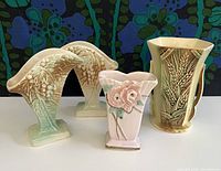 Front view showing four vintage McCoy ceramic vases to depict design and condition