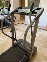 Front-right angle view showing handlebars, control panel, and running belt.