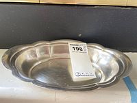 Top view of oval bowl with scalloped edge and surface wear