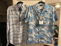 Both Villebrequin linen long sleeve shirt and APC short sleeve aviation print shirt hanging side by side