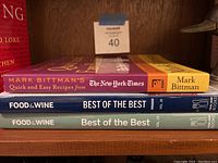 Side view of book spines showing Mark Bittman's Quick and Easy Recipes from The New York Times and two Food & Wine Best of the Best volumes 13 and 16.