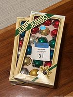 Two unopened boxes of vintage Pyramid Jumbo Christmas ornaments showing classic colors and packaging with wear