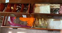 Drawer view showing fabric placemats and napkins in assorted patterns including plain and floral prints