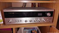 Front view of Realistic STA-47 stereo receiver showing control knobs, selector options, and wooden casing.
