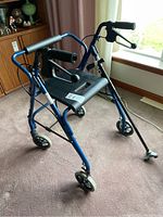 Dana Douglas 4200DX collapsible walker with padded seat, handbrakes, backrest, and wheels.
