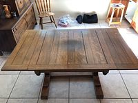 Full top view of the antique oak table showing wood grain and parquet style inlaid slats with a darker spot near the center, framed by a wider border.