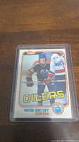 Front side of 1981-82 Topps Wayne Gretzky hockey card, showing player in Oilers uniform with team name and position centered below photo.