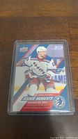 Photo of Alexis Lafreniere Rookie Moments hockey card from January 28, 2021, in protective sleeve.