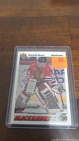 Front view of Dominik Hasek rookie hockey card in plastic case showing him in Chicago Blackhawks goalie gear.