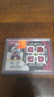 Clear image of Ed Jovanovski Black Diamond hockey jersey card with four embedded jersey pieces inside protective plastic case.