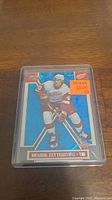 Close-up photo of Henrik Zetterberg rookie hockey card serial numbered 70 out of 699 in plastic protective holder.
