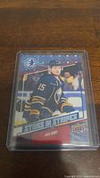 Jack Eichel rookie hockey card in protective case, front view showing player in Buffalo Sabres jersey number 15.