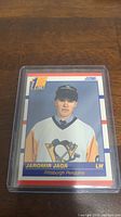 Photo of Jaromir Jagr rookie card in protective plastic sleeve showing card face and details.