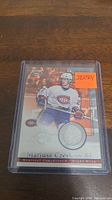 Photo of Mariusz Czerkawski hockey jersey card in protective case, featuring embedded jersey swatch and player image in Canadiens uniform.