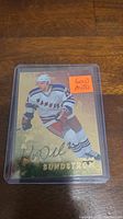 Photo of the Niklas Sundstrom gold autograph hockey card inside a protective plastic case showing the autograph and card details.