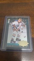 Photo of a Wayne Gretzky hockey card encapsulated in a protective plastic case. Card shows Gretzky in Edmonton Oilers uniform on ice.