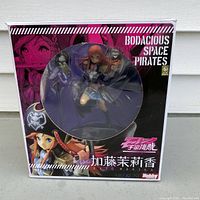 Front view of the figurine box showing Marika Kato figure inside with pirate hat, sword, and anime graphic design on packaging.