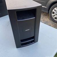 Front view of the Bose PS28 III subwoofer speaker showing vent opening and Bose logo plaque.