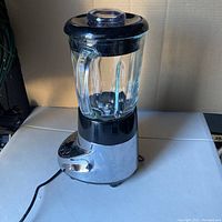 Full view of Cuisinart SmartPower Duet Blender with glass pitcher and black lid on chrome base.