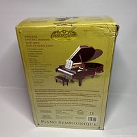 Back side of box showing song list in multiple languages and description of music box contents, including 5 Christmas carols and 4 classic tunes.