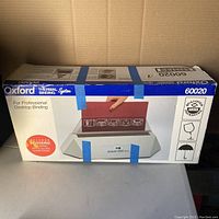 Box of Oxford Thermal Binding System model 60020 sealed with blue tape showing front image and features, including 5 covers.