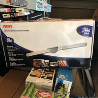 Box of RCA amplified indoor/outdoor antenna showing front panel details including 18 dB gain and support for 1080 HDTV.