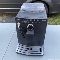 Front view of Saeco Intuita espresso maker showing control panel, bean hopper and drip tray