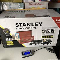 Box showing Stanley Black Chrome 101-piece tool set with images of tools and toolbox on the front.