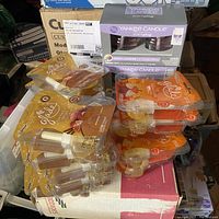 Lot showing stacked Glade scented wax melts and boxed Yankee Candle ScentPlug refills on boxes.