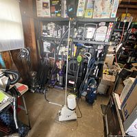 Full view of the Jiffy Clothes Steamer standing in a room with other appliances.