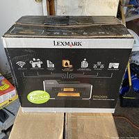 Box of Lexmark PRO915 printer showing branding and features including wireless, smart solutions, 50-page automatic document feeder, Ethernet and touchscreen.