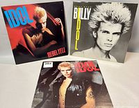 Front cover of three Billy Idol record albums 'Rebel Yell', 'Don't Stop', and 'Billy Idol' showing cover art