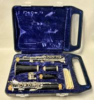 Yamaha YCL-24 clarinet disassembled inside blue velvet-lined case showing body sections and accessories.