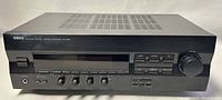Front view of Yamaha RX-396 stereo receiver showing full width with buttons, display and volume knob.