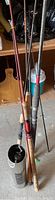 Set of five fishing rods, one visibly broken, with various handle types and reel seats