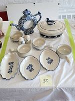 Photo shows full set including Dedham lidded bowl, Asian-style donut teapot, Pfaltzgraff Blue Yorktowne soup crocks, bowls, salt and pepper shakers, and scalloped dishes.