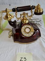 Front side showing rotary dial, handset, and base with brass and wood details