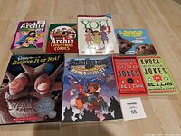 Photo of the lot showing all 8 books laid flat, displaying book covers with titles and artwork visible.