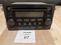 Front view of black Honda DVD stereo with buttons and display, showing control knobs and CD/DVD slot