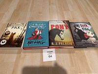 Photo showing all four books in the lot laid out side by side: Pax, A Boy Called Christmas, Pony, and The Story of Diva and Flea.