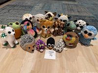 Full lot of 16 assorted Ty Beanie Boos plush toys on floor.