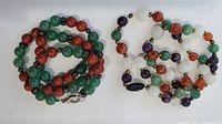Two gemstone bead necklaces laid side by side.