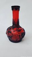 Front view of red and black cameo glass vase