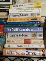 Shelf with 11 books related to health, healing, diet, natural medicine, and self help including titles like High-Speed Healing, Nature's Medicines, and Fight Fat.