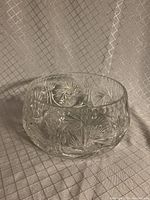 Crystal bowl with pinwheel and starburst pattern shown from side angle to highlight texture and shape.