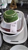 Photo of CorningWare green exterior bowl and multiple white baking dishes stacked together