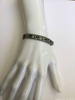 Silver panel bracelet displayed on white mannequin hand, showing fit and design detail.